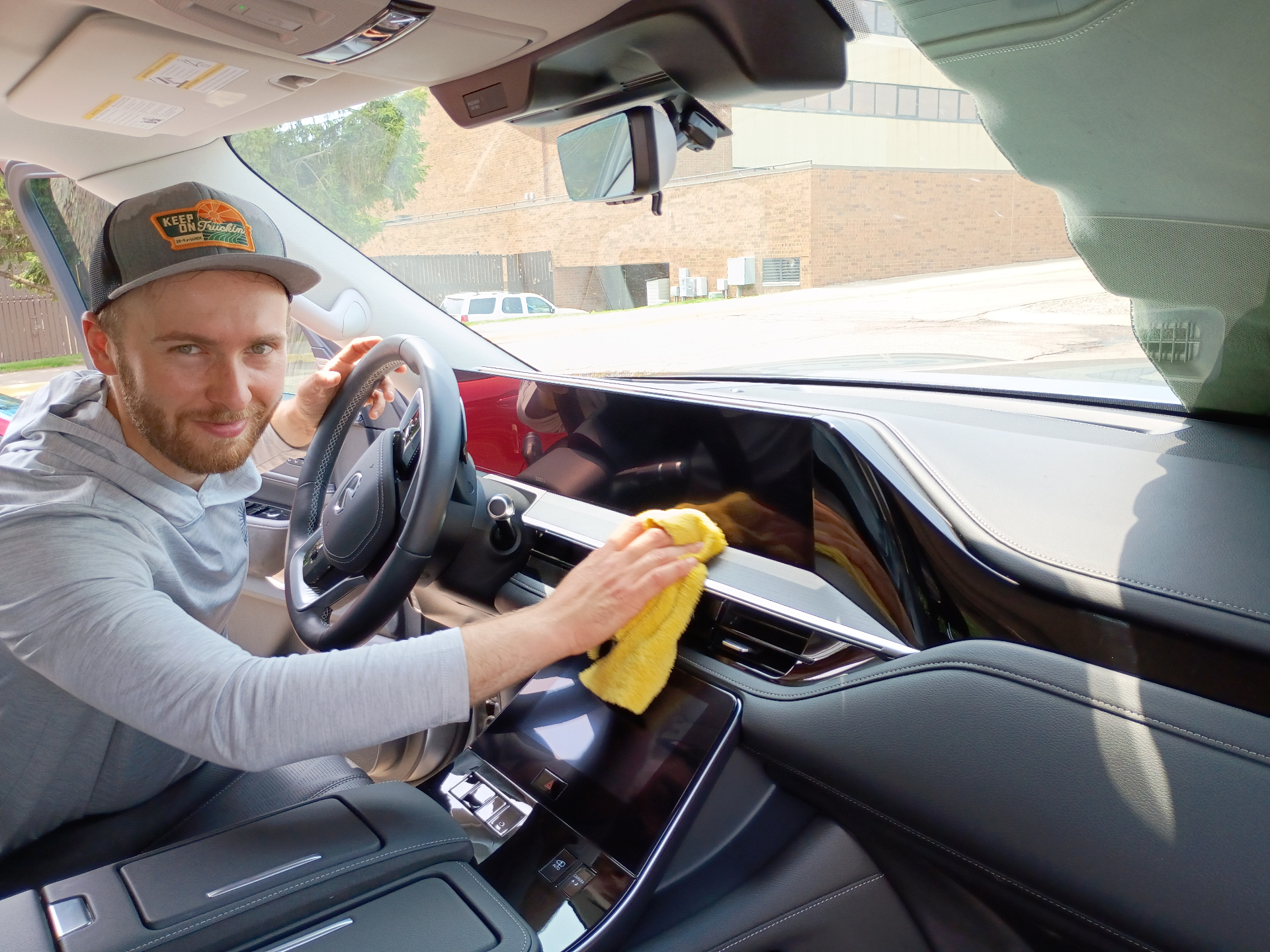 Just-In Time mobile detailer cleaning a vehicle interior with a microfiber cloth